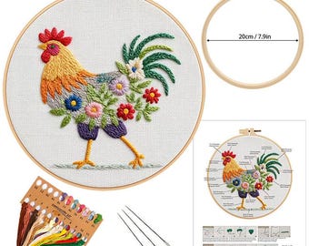 May include: A rooster embroidery kit featuring a colorful rooster design with floral accents. The embroidery is set in a wooden hoop, approximately 7.9 inches (20 cm) in diameter. The kit includes embroidery floss, needles, and a detailed diagram.