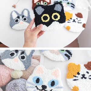 May include: A set of six colorful cat-shaped needle felted coasters. The coasters are made of wool and have different colored fur, eyes, and noses.