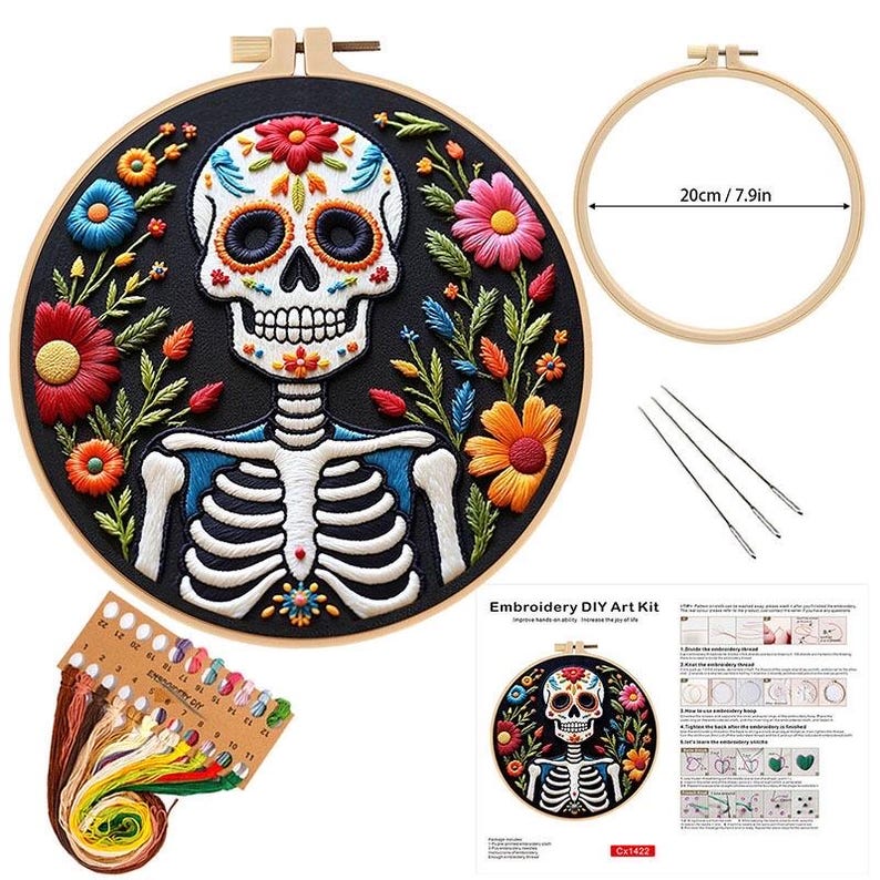 May include: An embroidery DIY art kit featuring a Day of the Dead skull design. The kit includes a black fabric hoop with a colorful skull and floral embroidery, embroidery floss, needles, and a wooden embroidery hoop measuring 7.9 inches (20cm) in diameter.