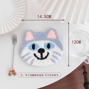 May include: A white, blue, and pink cat-shaped coaster with a smiling face. The coaster measures 14.5 inches wide and 12 inches tall.  Note: Hand-measured sizes may vary.