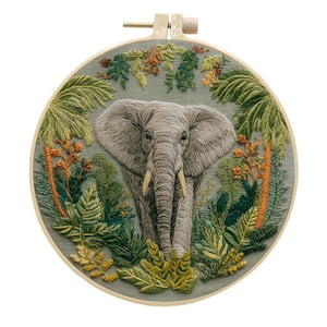 May include: A detailed embroidery hoop art piece featuring an elephant in a jungle setting. The elephant is gray with detailed texture, surrounded by lush green and orange foliage. The embroidery is set in a round wooden hoop.