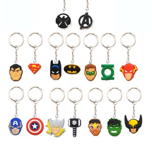 May include: Set of 16 superhero keyrings featuring characters such as Superman, Batman, Captain America, Thor, and Wolverine. Each keyring has a silver metal ring and a colourful rubber charm.