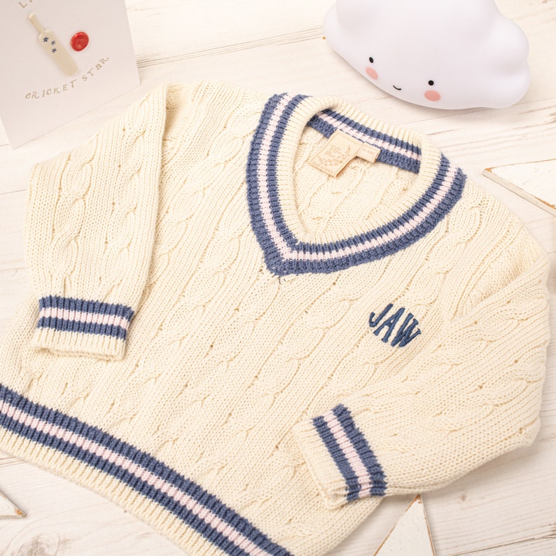 baby girl cream cricket jumper with pink and blue stripes