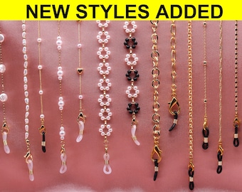 May include: A selection of 10 different styles of gold chain eyeglass retainers. The chains feature various designs including pearls, beads, and simple links.  The retainers are made of gold metal and have clear silicone loops on the ends.