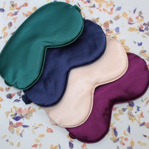 A group of silk sleep masks in different colours.  Available in green, navy, pink and maroon.  Perfect for him and for her.