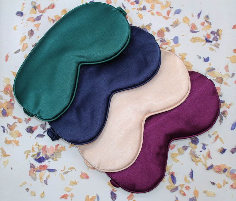 A group of silk sleep masks in different colours.  Available in green, navy, pink and maroon.  Perfect for him and for her.