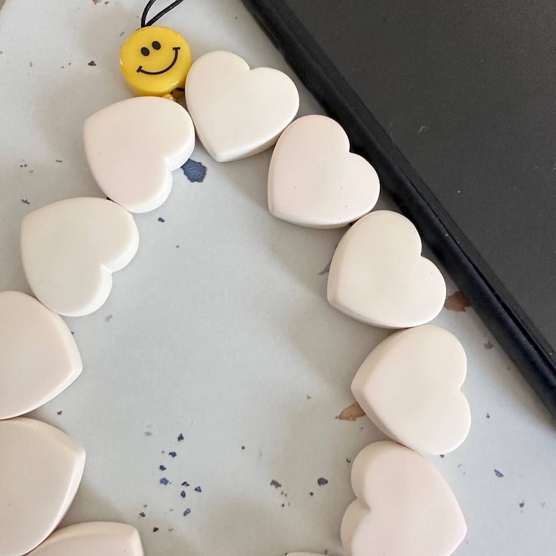 White phone charms with smiley.  Mobile phone charms, mobile phone chain accessory.  White heart phone strap.