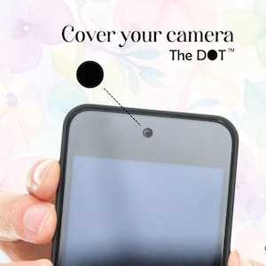 May include: A black phone with a screen is held in front of a floral background. The text "Cover your camera The DOT" is at the top. A black dot points to the camera lens.