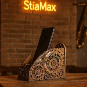 May include: A wooden phone holder featuring a steampunk gear design. The holder has a slot for a phone and is decorated with intricate gear patterns. The background features a neon sign that says "StiaMax".