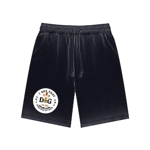 May include: Dark grey shorts with a drawstring waist and pockets. A white circular graphic on the left leg features the text "I GOT THAT DOG IN ME DISCIPLE OF GOD" with a dog illustration. The shorts are made of a soft, comfortable material.