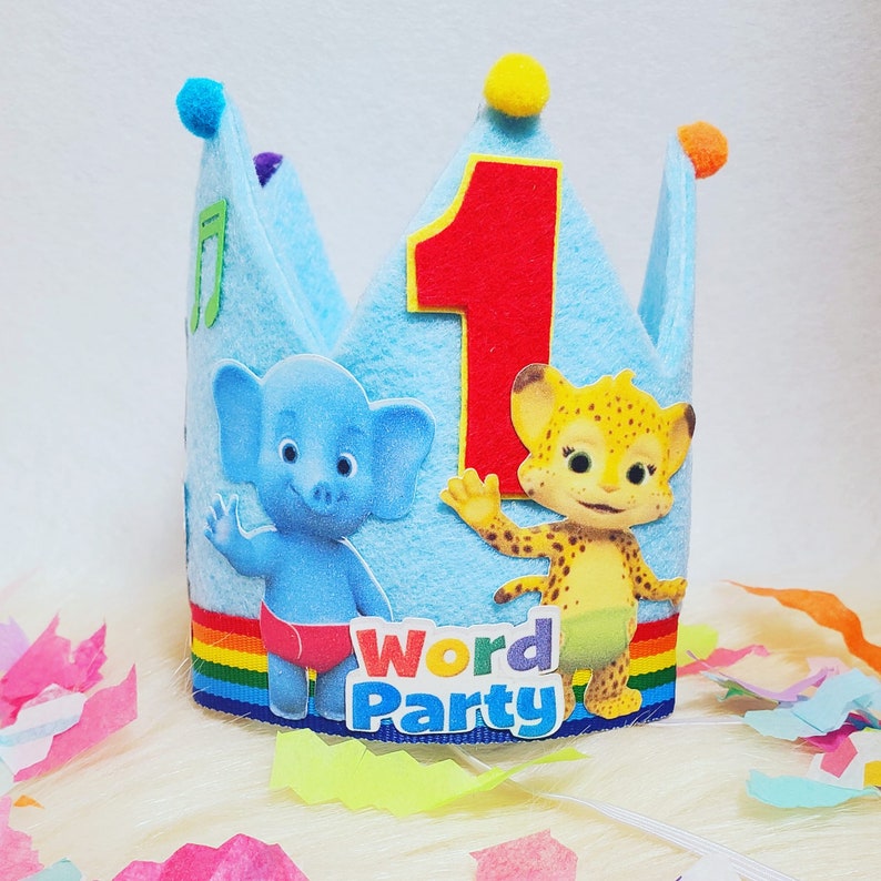 May include: Blue felt crown with a red felt number one, a blue elephant and a yellow cheetah, with the words "Word Party" on the front.