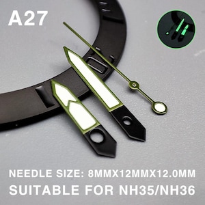 Op de afbeelding: Set wijzerplaten met een zwarte basis en groene en witte accenten. De set bevat uur-, minuten- en secondewijzers. De tekst "A27" is zichtbaar. De tekst "NEEDLE SIZE: 8MMX12MMX12.0MM SUITABLE FOR NH35/NH36" is ook zichtbaar.