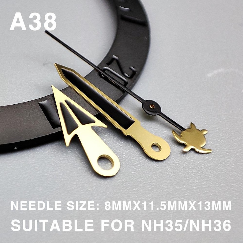 May include: A collection of watch hands in gold and black. The set includes a gold arrow-shaped hand, a gold and black rectangular hand, and a black hand with a gold turtle design. The text "A38" is visible. The text "NEEDLE SIZE: 8MMX11.5MMX13MM SUITABLE FOR NH35/NH36" is also visible.
