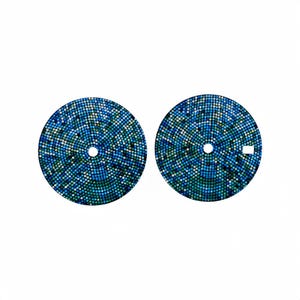 May include: Two watch dials featuring a mosaic pattern in shades of blue and green. Each dial has a central hole and a small rectangular cutout. The mosaic design is made of small, evenly spaced dots.