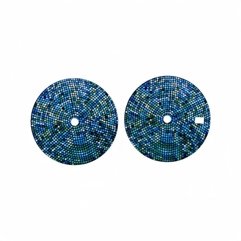 May include: Two watch dials featuring a mosaic pattern in shades of blue and green. Each dial has a central hole and a small rectangular cutout. The mosaic design is made of small, evenly spaced dots.