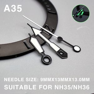 May include: Black and white watch hands with a luminous green glow. The set includes a second hand, minute hand, and hour hand. The text "A35" is visible. Needle size: 9mm x 13mm x 13.0mm. Suitable for NH35/NH36.