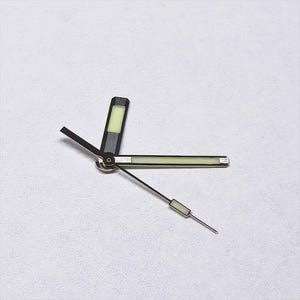 May include: Watch hands set, featuring a black and silver design with luminous green accents. The hour hand is a rectangular shape, the minute hand is a long rectangle, and the second hand is a thin line with a small rectangle.