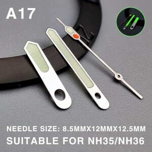 Op de afbeelding: Zilveren horlogewijzers met lichtgevende groene en rode details. De afbeelding bevat de tekst "A17" en "NEEDLE SIZE: 8.5MMX12MMX12.5MM SUITABLE FOR NH35/NH36". Geschikt voor horlogereparatie of -aanpassing.
