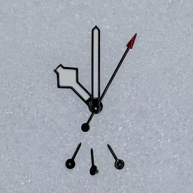 May include: Watch hands set. The set includes a white and black hour hand, a black minute hand, a black second hand with a red arrow tip, and three small black hands. The hands are designed for a watch.