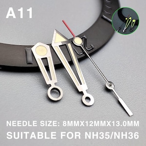 May include: Watch hands set with silver and gold accents, including a red second hand. The text "A11" is visible. The text "NEEDLE SIZE: 8MMX12MMX13.0MM SUITABLE FOR NH35/NH36" is also visible.