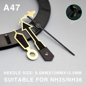 May include: Close-up of watch hands with gold and black accents. The hands include an arrow, a plane, and a straight hand. The text "A47" is visible. The text "NEEDLE SIZE: 8.5MMX12MMX12.5MM SUITABLE FOR NH35/NH36" is also visible.