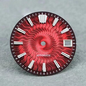 May include: A circular watch dial featuring a vibrant red sunburst pattern with a wavy, textured finish. It includes silver-toned applied hour markers, a date window at the three o'clock position, and the word AUTOMATIC printed in white.