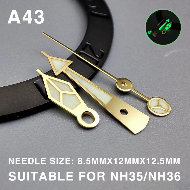 May include: Gold-toned watch hands with luminous white accents. The set includes hour, minute, and second hands. The text "A43" is visible. The text "NEEDLE SIZE: 8.5MMX12MMX12.5MM SUITABLE FOR NH35/NH36" is also visible.