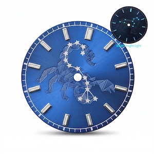 May include: A blue watch face featuring a geometric scorpion design and star accents. Rectangular silver hour markers are spaced around the edge. A smaller, illuminated version of the face shows the constellation. Text reads "BGW night light."