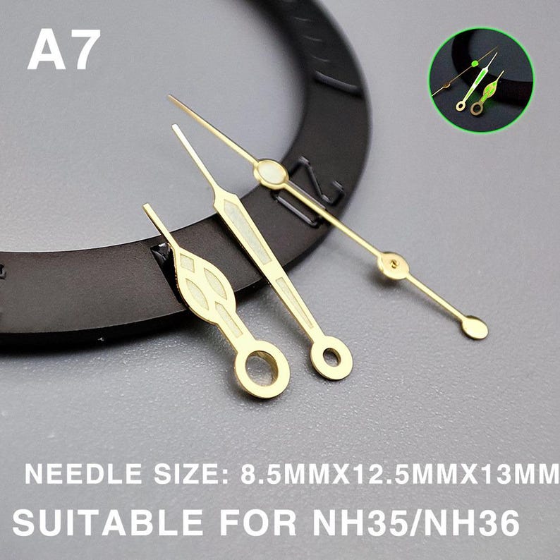 May include: Gold-toned watch hands in various styles, including a long, thin hand with a circular end and a shorter hand with a decorative design. The text "A7" is visible. The needle size is 8.5mm x 12.5mm x 13mm. Suitable for NH35/NH36.