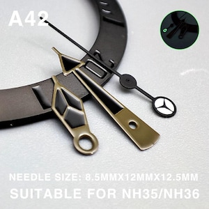 May include: Close-up of watch hands in various styles. The hands are black, gold, and white. The text "A42" is visible. The text "NEEDLE SIZE: 8.5MMX12MMX12.5MM SUITABLE FOR NH35/NH36" is also visible.