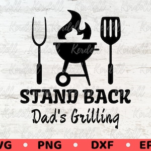 May include: Black and white graphic design with a grill, spatula, and fork. The text reads "Stand Back Dad's Grilling".