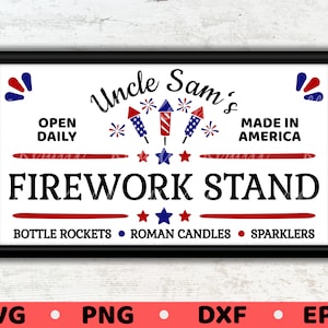 May include: A white sign with red and blue stars and stripes, with the text "Uncle Sam's Firework Stand" in black. The sign also says "Open Daily", "Made in America", "Bottle Rockets", "Roman Candles", and "Sparklers".