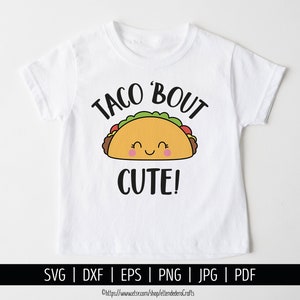 May include: White t-shirt with a black and yellow cartoon taco with a smiling face and the text "Taco 'Bout Cute!" printed on it.