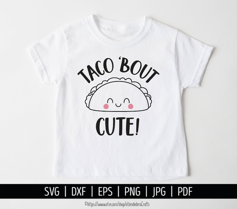 May include: White t-shirt with a black and white illustration of a smiling taco with the text "Taco 'Bout Cute!" printed on it.