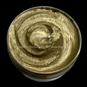 May include: A close-up of a gold metallic sculpting paste in a white container. The label reads "Ezgi Cercetin Fine Art Premium 3D Sculpture Painting Paste/Modeling Paste".