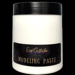 May include: White modelling paste in a round plastic jar with a black lid. The jar has a black label with gold text that reads "Ezgi Sertecetin Fine Art Modelling Paste".