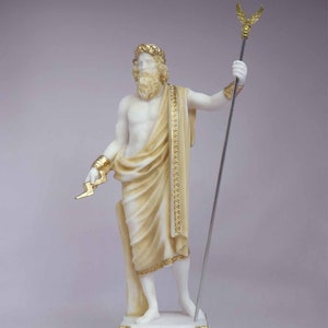 May include: White marble statue of Zeus, the Greek god of the sky and thunder, holding a lightning bolt in his left hand and a scepter in his right hand. He is wearing a golden crown and a toga. The statue is on a white marble base with the word "ZEUS" inscribed in gold letters.