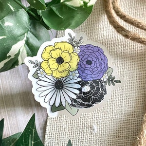 May include: A sticker featuring a bouquet of flowers in shades of yellow, purple, and black. The flowers are stylized and have a whimsical feel.