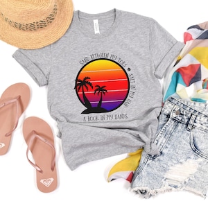 May include: Gray t-shirt with a sunset graphic and the text "Sand between my toes, salt in my hair, a book in my hands".