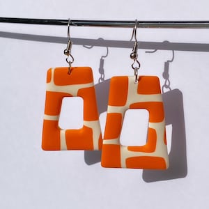 Retro orange and white print slanted rectangle dangle polymer clay earrings