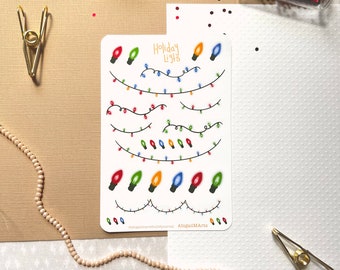 May include: A sticker sheet featuring colorful illustrations of holiday lights. The design includes various strings of lights with red, green, orange, and blue bulbs. The words "Holiday Lights" are written at the top of the sheet.