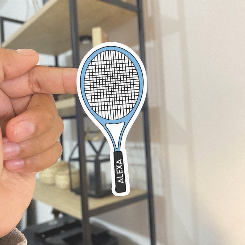 以下が含まれることがあります： ハンドルに「ALEXA」と印刷された青と白のテニスラケットのステッカーです。