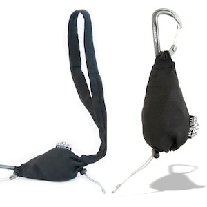 May include: A black fabric pouch with a silver carabiner clip and a WildKat logo. The pouch is attached to a long black strap.