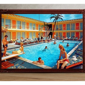 May include: A vintage photograph of a motel pool with people swimming and lounging around the pool. The pool is surrounded by a yellow building with orange accents and palm trees.