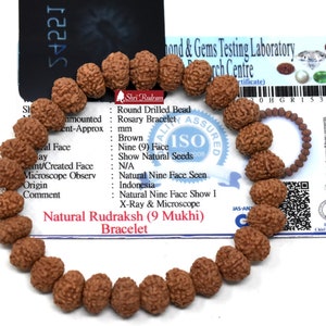 May include: A brown Rudraksha 9 Mukhi bracelet made of natural seeds. The bracelet is certified by a laboratory and features a quality assurance seal. The certificate includes details about the beads, including their origin, size, and number of faces. The bracelet is a traditional Hindu religious item.