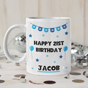 May include: White ceramic mug with a blue and white design. The mug says "Happy 21st Birthday Jacob" with blue stars and balloons.
