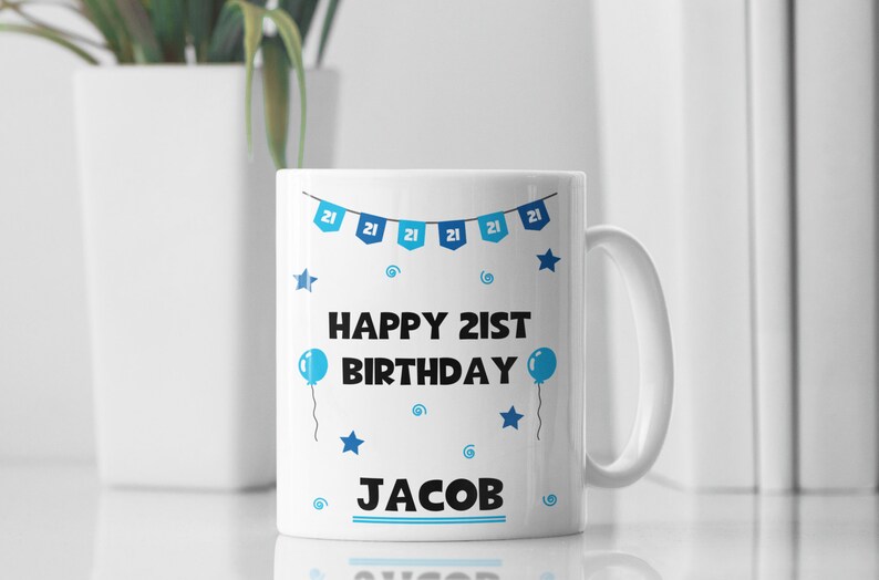 May include: White ceramic mug with a blue and white design. It says "Happy 21st Birthday Jacob" with blue stars and balloons.