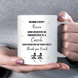 May include: White ceramic mug with the text "BEHIND EVERY Rower WHO BELIEVES IN THEMSELVES IS A Coach WHO BELIEVED IN THEM FIRST! Thank you Frank". The mug has a rowing graphic and star accents.