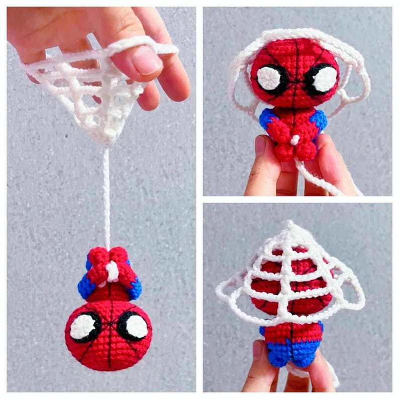 May include: A small, handmade crochet amigurumi figure of a red and blue superhero character with large white eyes. The figure is attached to a white crocheted web structure, showing the character hanging upside down and also standing upright.