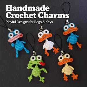 May include: Handmade crochet charms in the shape of whimsical animals, including a blue duck, a white duck, a green frog, and a yellow duck. The charms have large eyes and are attached to black lanyards. Text reads "Handmade Crochet Charms, Playful Designs for Bags & Keys."